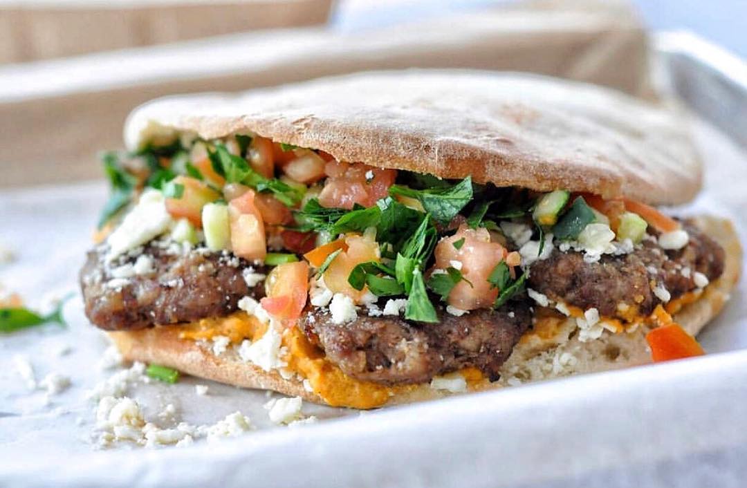 A MezzeMe pita filled with grilled meat, vegetables and sauce