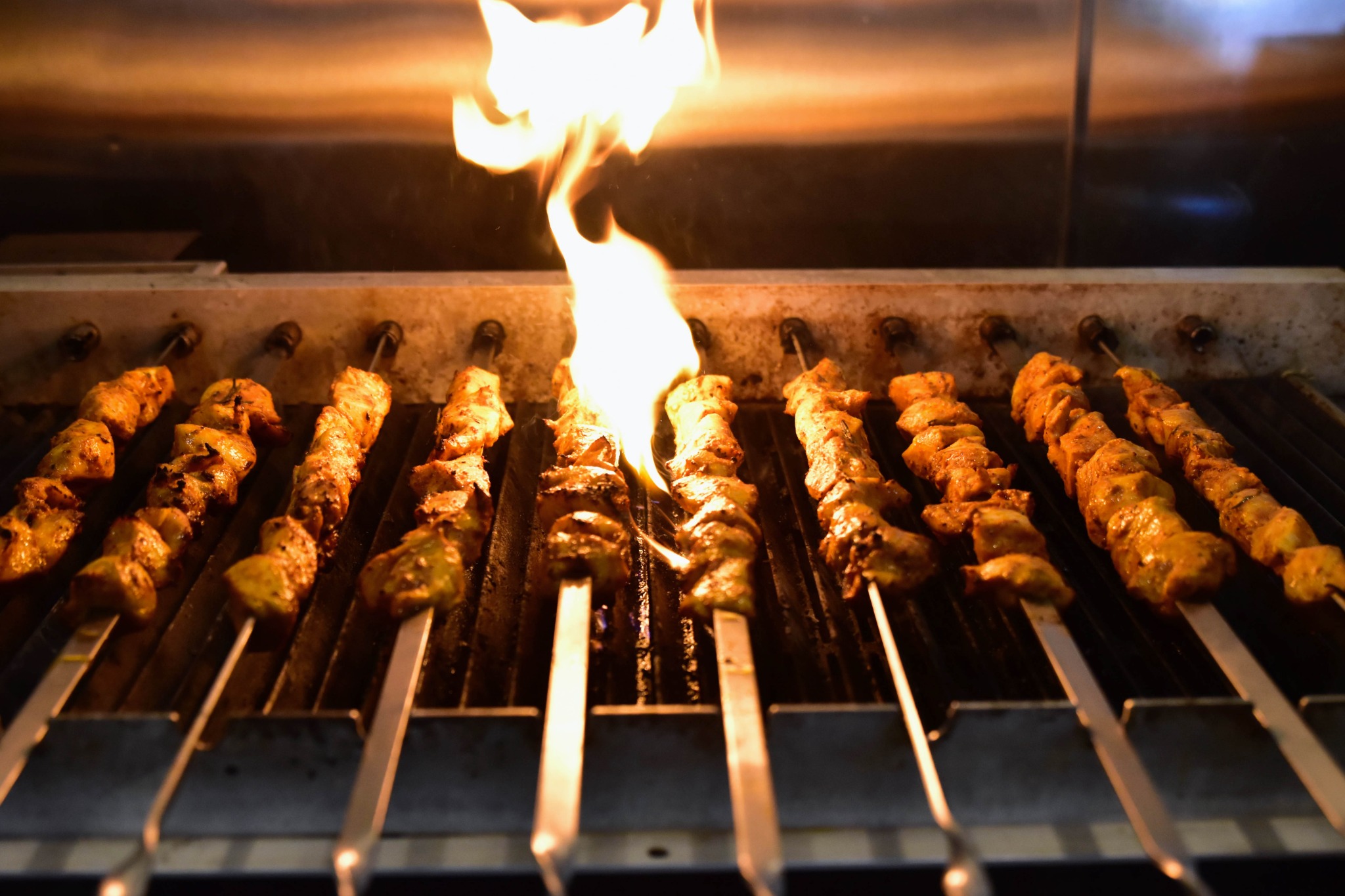 MezzeMe kebaps cooking over an open flame